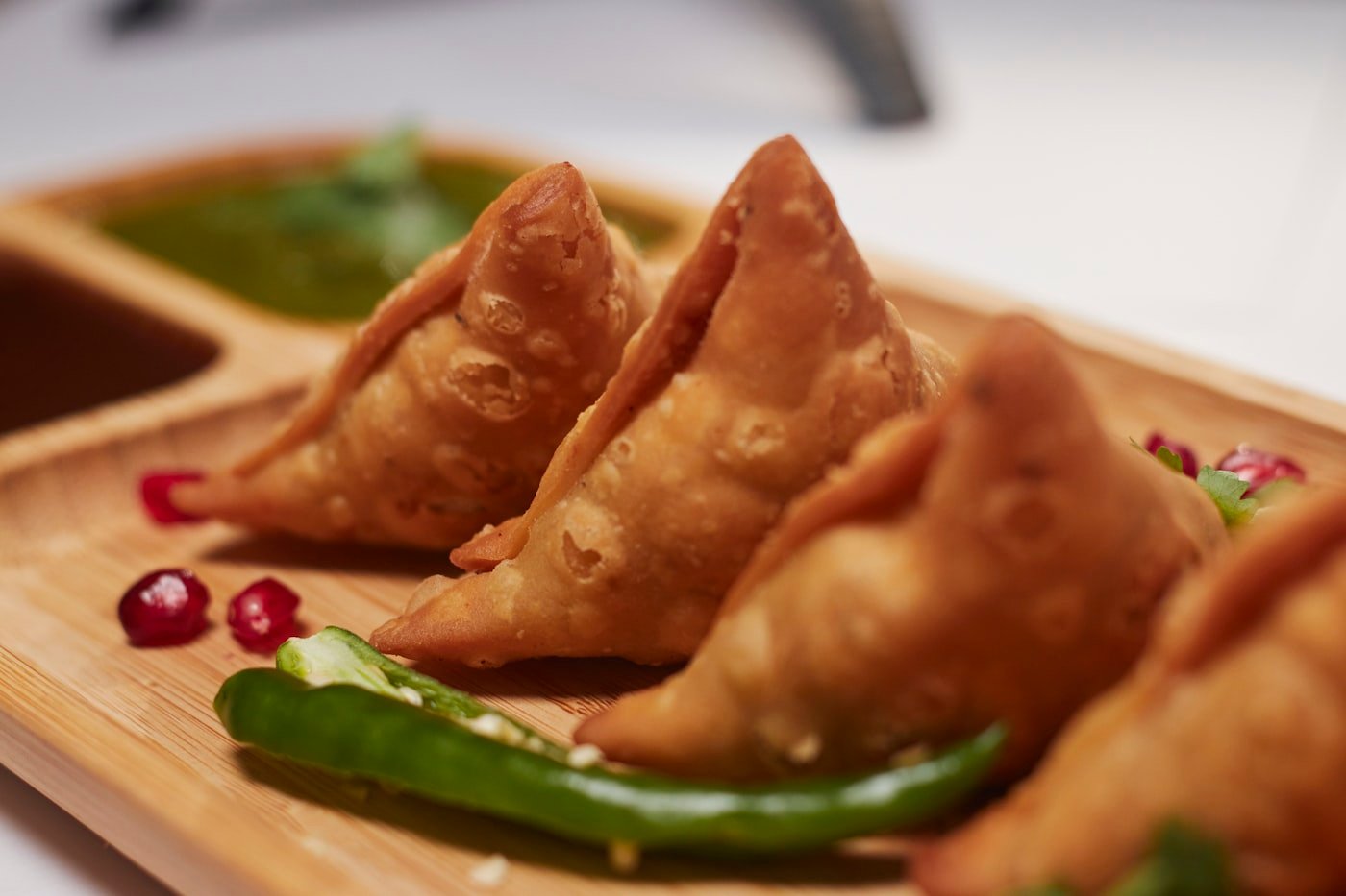 Freshly fried empanadas on a serving board