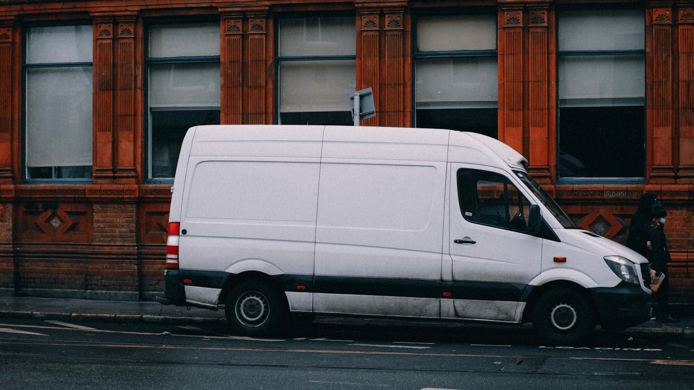 White cargo delivery van parked on a city street